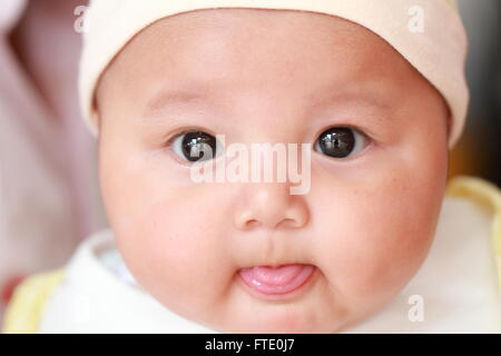 Cute baby looking at the camera Stock Photo