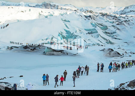 Tourists on Solheimajokull glacier Stock Photo