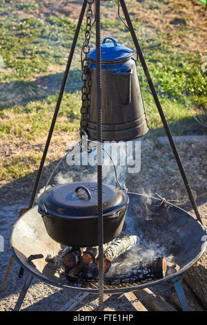 coffee pot boiling over an open fire cowboy flame smoke caffine wild west  Stock Photo - Alamy