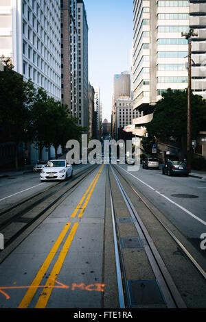 Skyscrapers along street with tram tracks in San Francisco, California. Stock Photo