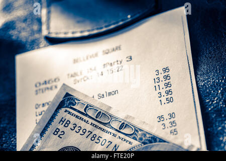 Cafe paper cheque with dollars in blue toning Stock Photo