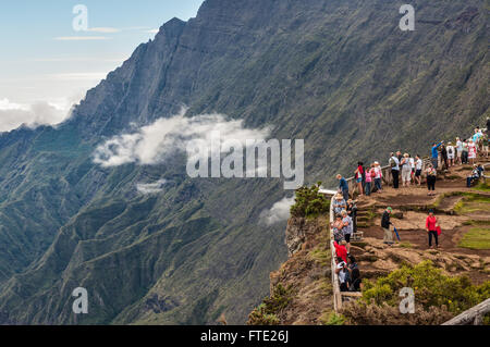 Tourists on the Maido lookout overlooking Cirque of Mafate Stock Photo