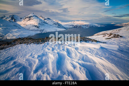 Sastrugi and view towards Store Blamann and the open ocean from Rodtinden, Kvaloya, Troms, Northern Norway Stock Photo