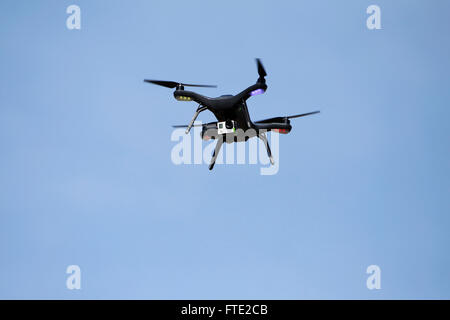 A quadcopter drone in flight. Stock Photo