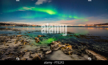 Aurora Borealis dancing over fjord, Tromso Northern Norway Stock Photo