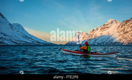 Winter kayaking in Ersfjord, Kvaloya near Tromso Northern Norway Stock Photo