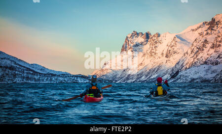 Winter kayaking in Ersfjord, Kvaloya near Tromso Northern Norway Stock Photo