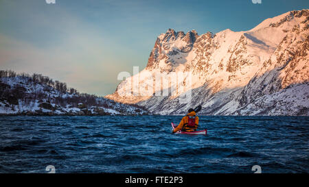 Winter kayaking in Ersfjord, Kvaloya near Tromso Northern Norway Stock Photo