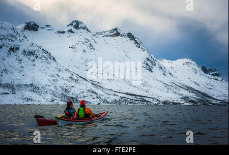 Winter kayaking in Ersfjord, Kvaloya near Tromso Northern Norway Stock Photo