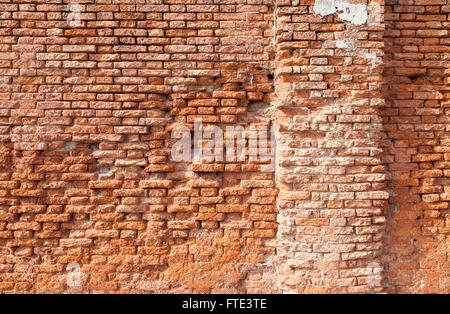Richly warm coloured crumbling brickwork in a brightly sunlit wall along Fondamemta al Saloni in Venice, Italy Stock Photo