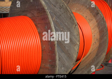 Huge orange cable drums for optic fibre connections. Stock Photo