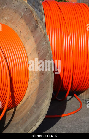 Huge orange cable drums for optic fibre connections. Stock Photo