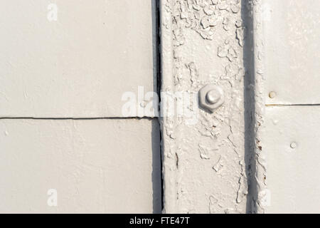 Close up architectural image of grey painted bolts used for securing light metal plates and structures. Horizontal composition Stock Photo