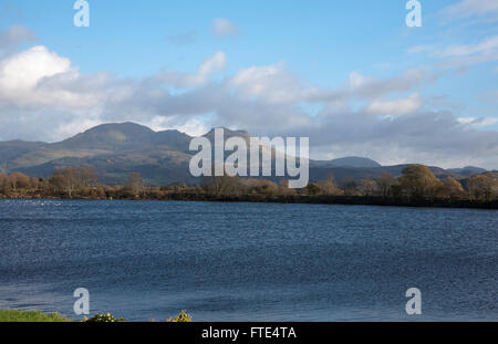 Moelwyn Mountains looking across the flooded estuary of The Afon Glaslyn from the Cob at Porthmdog Snowdonia Wales Stock Photo