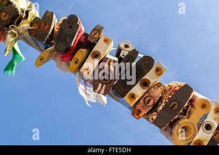 Line of various old rusting metal padlocks in different shapes locked and secured. Blue clear background sky area with copy spac Stock Photo