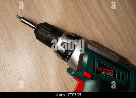 UFA - RUSSIA 23RD FEBRUARY 2016 - A hammerflex electric drill rests on a wooden background. The make is popular amongst DIY enth Stock Photo