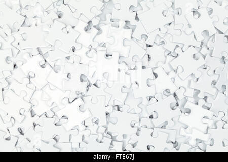 Pile of White Blank Puzzle Pieces Background. Stock Photo