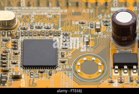 Close Up of Microchip on Yellow Green Circuit Board. Stock Photo