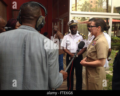 160122-N-RU135-004 DOUALA, Cameroon (Jan. 22, 2016) Commodore, Military Sealift Command Europe and Africa / Commander, Task Force 63, Capt. Heidi Agle, speaks at a press conference along with Cameroonian military representatives Jan. 22, 2016. Agle was on hand to discuss the upcoming Exercise Obangame Express 2016, part of the international collaborative capacity-building program Africa Partnership Station.  U.S. 6th Fleet, headquartered in Naples, Italy, conducts the full spectrum of joint and naval operations, often in concert with allied, joint, and interagency partners, in order to advance Stock Photo