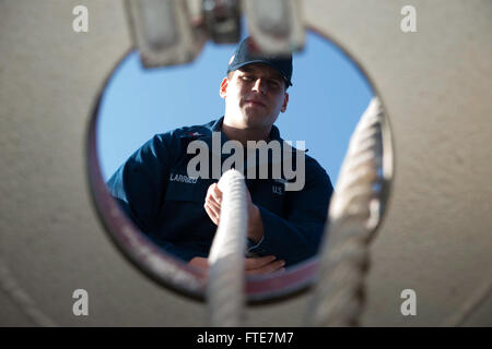 Aksaz, Turkey (Nov. 12, 2013) - Cryptology Technician (Collections) 2nd Class Tommy Larrieu sends mooring lines below deck aboard the Arleigh Burke-class guided-missile destroyer USS Stout (DDG 55) while departing Aksaz Naval Base, to support Exercise Dogu Akdeniz 2013. The exercise was hosted by Commander, Turkish Fleet to support interoperability efforts. Stout, homeported in Norfolk, Va., is on a scheduled deployment supporting maritime security operations and theater security cooperation efforts in the U.S. 6th Fleet area of operation. (U.S. Navy photo by Mass Communication Specialist 2nd  Stock Photo