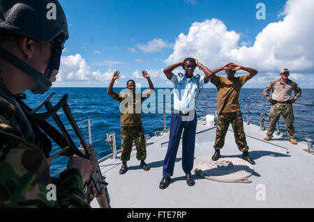 131113-N-EZ054-050 VICTORIA, Seychelles (Nov. 15, 2013) - A Seychelles Coast Guard boarding team member stands guard over the target vessels' ship's crew during the underway phase of Cutlass Express 2013. Exercise Cutlass Express 2013 is a multinational maritime exercise in the waters off East Africa to improve cooperation, tactical expertise and information sharing among East African maritime forces in order to increase maritime safety and security in the region. (U.S. Navy photo by Mass Communication Specialist Seaman Luis R. Chàvez Jr/Released.) Stock Photo