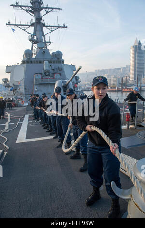 HAIFA, Israel (Jan. 19, 2014) -  Sailors aboard the Arleigh Burke-class guided-missile destroyer USS Stout (DDG 55) heave mooring lines as the ship pulls into the Haifa, Israel for a scheduled port visit. Stout, homeported in Norfolk, Va., is on a scheduled deployment supporting maritime security operations and theater security cooperation efforts in the U.S. 6th Fleet area of operation. (U.S. Navy photo by Mass Communication Specialist 2nd Class Amanda R. Gray/Released) Stock Photo