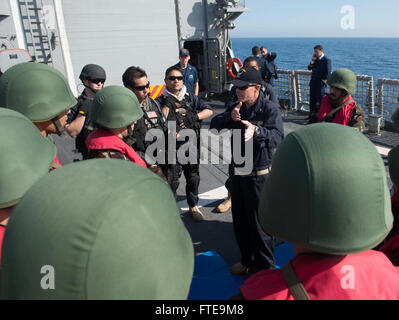 140206-N-SK590-317  MEDITERRANEAN SEA (Feb. 6, 2014) Chief Gunner’s Mate Robert Clay exchanges tactical techniques with members of the visit, board, search and seizure team assigned to the Royal Moroccan Navy Sigma-class corvette Allal Ben Abellah  (FMMM 615) during a passing exercise aboard the Oliver Hazard Perry-class guided-missile frigate USS Elrod (FFG 55). The exercise was held to increase the partnership between the two participating navies and strengthen maritime and theater security in the region. (U.S. Navy photo by Mass Communication Specialist 2nd Class Tim D. Godbee/Released) Stock Photo