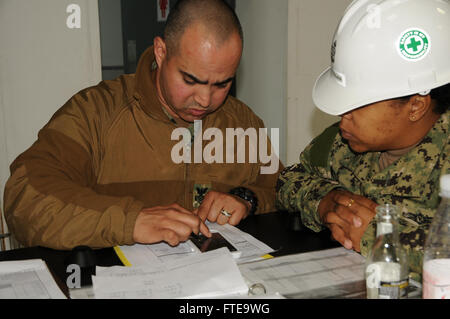 140213-N-YB423-014 ROTA, Spain (Feb. 13, 2014) - Steel Worker 1st Class Eric Tosado, assigned  to Naval Mobile Construction Battalion (NMCB) 74, reviews weighing and balancing with Chief Yeoman Harriet Douglas as part of an embarkation exercise on Camp Mitchell. (U.S. Navy photo by Mass Communication Specialist Ryan Williams)  Join the conversation on Twitter ( https://twitter.com/naveur navaf )  follow us on Facebook ( https://www.facebook.com/USNavalForcesEuropeAfrica )  and while you're at it check us out on Google+ ( https://plus.google.com/101085806745039159791/posts#101085806745039159791 Stock Photo