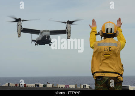140215-N-JX484-145 ATLANTIC OCEAN (Feb. 15, 2014)  Aviation Boatswain's Mate (Handling) 3rd Class Maauroravenus DeLuna, from Hagonoy Bulacan, Phillipines, directs an MV-22 Osprey onto the flight deck aboard the multipurpose amphibious assault ship USS Bataan (LHD 5). The Bataan Amphibious Readiness Group is deployed supporting maritime security operations, providing crisis response capability, increasing theater security cooperation and a forward naval presence in the U.S 5th and 6th Fleet areas of responsibility. (U.S. Navy photo by Mass Communication Specialist 3rd Class Mark Hays/Released) Stock Photo