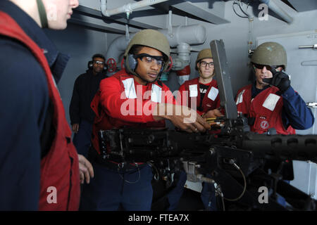 140223-N-SI489-020 ATLANTIC OCEAN (Feb. 23, 2014) Aviation Ordnanceman Airman Trevon Williams, from Virginia Beach, Va., loads a .50-caliber machine gun aboard the aircraft carrier USS George H. W. Bush. George H. W. Bush is on a scheduled deployment en route to support maritime security operations and theater security cooperation efforts in the U.S. 5th and 6th Fleet areas of responsibility. (U.S. Navy photo by Mass Communication Specialist Seaman Andrew Johnson/Released) Stock Photo