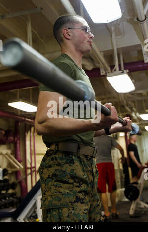 140301-M-MX805-155 AT SEA (Feb. 27, 2014) - Lance Cpl. Benjamin Spaulding, Battalion Landing Team 1st Battalion, 6th Marine Regiment, 22nd Marine Expedition Unit (MEU), lifts weights aboard the USS Mesa Verde (LPD 19). MEU is deployed to the U.S. 6th Fleet area of operations with the Bataan Amphibious Ready Group as a sea-based, expeditionary crisis response force capable of conducting amphibious missions across the full range of military operations. (U.S. Marine Corps photo by Cpl. Manuel A. Estrada/Released)  Join the conversation on Twitter ( https://twitter.com/naveur navaf )  follow us on Stock Photo