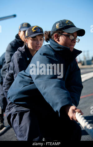 140302-N-WD757-101 MARSEILLE, France (March 2, 2014) – Logistics Specialist Seaman Makayla Johnson pulls a mooring line as the guided-missile destroyer USS Arleigh Burke (DDG 51) prepares to pull into Marseille, France for a scheduled port visit. Arleigh Burke is on a scheduled deployment in support of maritime security operations and theater security cooperation efforts in the U.S. 5th and 6th Fleet area of responsibility. (U.S. Navy photo by Mass Communication Specialist 2nd Class Carlos M. Vazquez II/Released)  Join the conversation on Twitter ( https://twitter.com/naveur navaf )  follow us Stock Photo