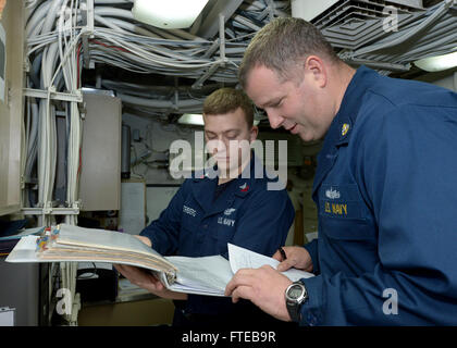 140308-N-CH661-023 MEDITERRANEAN SEA (March 8, 2014) - Chief Gunner’s Mate Jason Peugh assesses Yeoman 1st Class Jonathan Underberg on valves and valve operators during a 3M spot check aboard the guided-missile destroyer USS Ramage (DDG 61). Ramage, homeported in Norfolk, Va., is on a scheduled deployment supporting maritime security operations and theater security cooperation efforts in the U.S. 6th Fleet area of operations. (U.S. Navy photo by Mass Communication Specialist 2nd Class Jared King/Released)  Join the conversation on Twitter ( https://twitter.com/naveur navaf )  follow us on Face Stock Photo