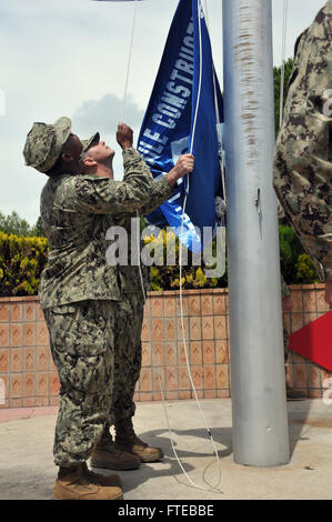 140624-N-EM343-080 NAVAL STATION ROTA, Spain (June 24, 2014) Seabees from Naval Mobile Construction Battalion (NMCB) 133 raise the battalion flag at the transfer of authority ceremony with Naval Mobile Construction Battalion (NMCB) 74. NMCB 133 assumed control of Camp Mitchell and ongoing Seabee missions throughout Europe and Africa during the ceremony. (U.S. Navy Photo by Chief Mass Communication Specialist William Clark/Released) Stock Photo