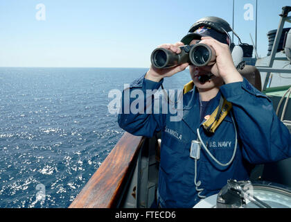 140319-N-CH661-051 MEDITERRANEAN SEA (March 19, 2014) - Boatswain’s Mate Seaman Ethan Giannolla, assigned to the guided-missile destroyer USS Ramage (DDG 61), scouts surface contacts during a starboard bridge wing lookout watch. Ramage, homeported in Norfolk, Va., is on a scheduled deployment supporting maritime security operations and theater security cooperation efforts in the U.S. 6th Fleet area of operations. (U.S. Navy photo by Mass Communication Specialist 2nd Class Jared King/Released)   Join the conversation on Twitter ( https://twitter.com/naveur navaf )  follow us on Facebook ( https Stock Photo