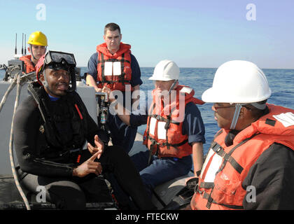 140322-N-CH661-009 MEDITERRANEAN SEA (March 22, 2014) - Seaman Joshua Edwards, assigned to the guided-missile destroyer USS Ramage (DDG 61), explains search and rescue swimmer duties in preparation for a simulated rescue. Ramage, homeported in Norfolk, Va., is on a scheduled deployment supporting maritime security operations and theater security cooperation efforts in the U.S. 6th Fleet area of operations. (U.S. Navy photo by Mass Communication Specialist 2nd Class Jared King/Released)   Join the conversation on Twitter ( https://twitter.com/naveur navaf )  follow us on Facebook ( https://www. Stock Photo