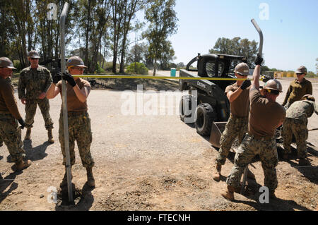 140325-N- YB423-008 ROTA, Spain (March 25, 2014) Seabees attached to Naval Mobile Construction Battalion 74 Detail Rota check measurement of fence posts as part of the Flight Line fence repair project.  (U.S. Navy photo by Mass Communication Specialist 2nd Class Ryan Williams)  Join the conversation on Twitter ( https://twitter.com/naveur navaf )  follow us on Facebook ( https://www.facebook.com/USNavalForcesEuropeAfrica )  and while you're at it check us out on Google+ ( https://plus.google.com/101085806745039159791/posts#101085806745039159791/posts ) Stock Photo