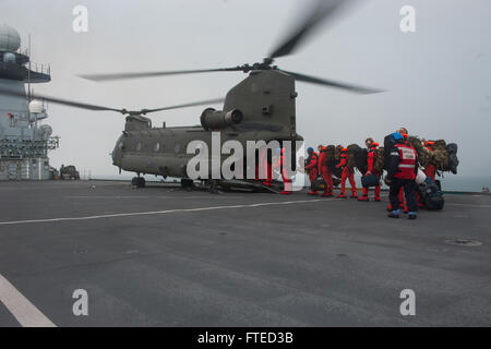 140403-N-WX580-095 NORTH SEA (Apr. 3, 2014) Royal Marines board an CH-47 Chinook helicopter from 27 squadron Royal Air Force to debark the Royal Navy aircraft carrier HMS Illustrious (R06) during exercise Joint Warrior 14-1.  Joint Warrior 14-1 is a semi-annual, United Kingdom led training exercise designed to provide NATO and allied forces a unique multi-warfare environment in which to prepare for global operations. The Joint Warrior exercise is intended to improve interoperability between allied navies in an operational challenging environment. (U.S. Navy photo by Mass Communication Speciali Stock Photo