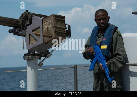 140419-N-NQ697-046 GULF OF GUINEA (April 19, 2014) – Chief Warrant Officer Ofemba Camille, Congolese navy, stands guard during a simulated boarding of the suspect vessel, CNS Jabane (P 105), as part of Obangame Express 2014.  Obangame Express is a U.S. Africa Command-sponsored multinational maritime exercise designed to increase maritime safety and security in the Gulf of Guinea.  (U.S. Navy photo by Mass Communication Specialist 3rd Class Matt Wright/released)  Join the conversation on <a href='https://twitter.com/naveur navaf' rel='nofollow'>Twitter</a> follow us on <a href='https://www.face Stock Photo
