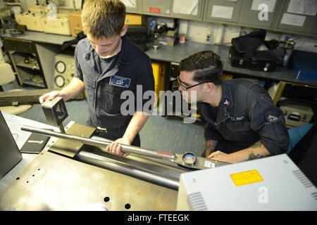 140528-N-MW280-055: MEDITERRANEAN SEA (May 28, 2014) - Machinist's Mate 2nd Class Joseph Shelow and Aviation Electronics Technician Airman Apprentice Frank Hudson calibrate a torque wrench aboard the multipurpose amphibious assault ship USS Bataan (LHD 5). Bataan, with elements of the 22nd Marine Expeditionary Unit, is operating in the in U.S. 6th Fleet area of operations to augment U.S. Crisis Response forces in the region. (U.S. Navy photo by Mass Communication Specialist 3rd Class Chase Hawley/Released) Join the conversation on Twitter ( https://twitter.com/naveur navaf )  follow us on Face Stock Photo