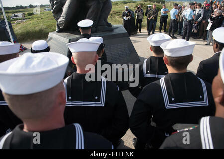 140605-N-YO152-132 UTAH BEACH, France (June 5, 2014) - Sailors assigned to the guided-missile destroyer USS Oscar Austin (DDG 79) stand at parade rest while awaiting commencement of the D-Day ceremony at the Navy Memorial on Utah Beach. The event was one of several commemorations of the 70th Anniversary of D-Day operations conducted by Allied forces World War II June 5-6, 1944. Over 650 U.S. military personnel have joined troops from several NATO nations to participate in ceremonies to honor the events at the invitation of the French government. (U.S. Navy photo by Mass Communication Specialis Stock Photo