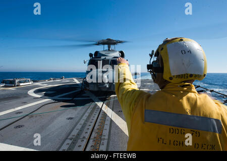 140608-N-YO152-047 NORTH SEA (June 8, 2014) - Boatswain's Mate Seaman Michael Hungelmann signals to a MH-60R helicopter assigned to the Proud Warriors of Helicopter Maritime Strike Squadron (HSM) 72 during flight quarters aboard USS Oscar Austin (DDG 79). Oscar Austin, homeported in Norfolk, Va., is on a scheduled deployment supporting maritime security operations and theater security cooperation efforts in the U.S. (U.S. Navy photo by Mass Communication Specialist 3rd Class (SW) DJ Revell/released) Stock Photo