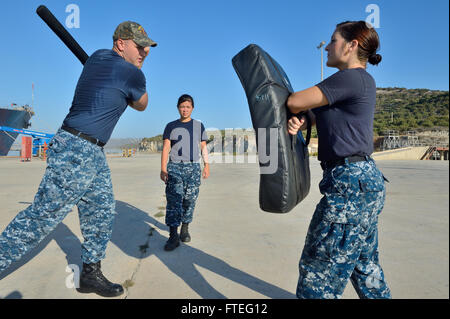 140828-N-IY142-145 SOUDA BAY, Greece (Aug. 28, 2014) Fire Controlman 2nd Class Brian Beddoes demonstrates baton techniques during force protection training with Sailors from the Arleigh Burke-class guided-missile destroyer USS Ross (DDG 71). Ross, forward deployed to Rota, Spain, is conducting naval operations in the U.S. 6th Fleet area of operations in support of U.S. national security interests in Europe. (U.S. Navy photo by Mass Communication Specialist 2nd Class John Herman/Released) Stock Photo