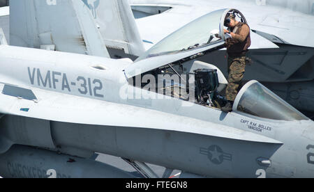 MEDITERRANEAN SEA (August 12, 2013) Lance Cpl. Ricardo Robles, assigned to Marine Fighter Attack Squadron 312 “Checkerboards,” cleans the windshield of an F/A-18C Hornet in preparation for flight operations on the flight deck of aircraft carrier USS Harry S. Truman (CVN 75). Harry S. Truman, flagship for Harry S. Truman Carrier Strike Group, is deployed supporting maritime security operations and theater security cooperation efforts in the U.S. 6th Fleet area of responsibility. Stock Photo