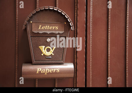 New and beautiful mail box on a metal gate Stock Photo