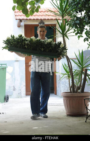 NAPLES, Italy (Oct. 13, 2014) - Cmdr. Anthony Savage participates in yard work for a local church during community relations project in Naples, Italy. Bataan, homeported in Norfolk, Va., is conducting naval operations in the U.S. 6th Fleet area of operations in support of U.S. national security interests in Europe. Stock Photo