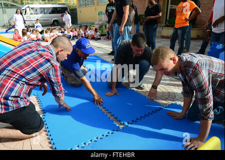 NAPLES, Italy (Oct. 13, 2014) - Sailors and Marines assigned to the amphibious assault ship USS Bataan (LHD 5) assemble playground equipment at a daycare run by the Franciscan Sisters of the Sacred Heart during a community relations event in Naples, Italy. Bataan, homeported in Norfolk, Va., is conducting naval operations in the U.S. 6th Fleet area of operations in support of U.S. national security interests in Europe. Stock Photo