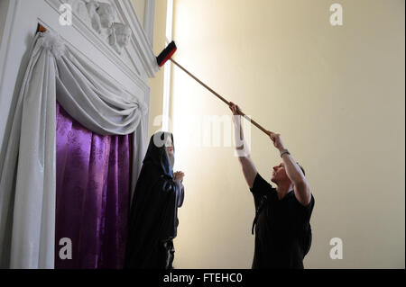 NAPLES, Italy (Oct. 13, 2014) - Sailors and Marines assigned to the amphibious assault ship USS Bataan (LHD 5) assist with cleaning the chapel at a daycare run by the Franciscan Sisters of the Sacred Heart during a community relations event while on a liberty port visit to Naples, Italy. Bataan, homeported in Norfolk, Va., is conducting naval operations in the U.S. 6th Fleet area of operations in support of U.S. national security interests in Europe. Stock Photo