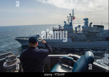 BLACK SEA (Oct. 16, 2014) – Ensign Michael Tomsic and Quartermaster 1st Class Christopher Allison aboard the Arleigh Burke-class guided-missile destroyer USS Cole (DDG 67) conduct communications exercises with the Turkish navy Barbaros-class frigate TCG Salihreis (F 246) during a passing exercise. Cole, homeported in Norfolk, Va., is conducting naval operations in the U.S. 6th Fleet area of operations in support of U.S. national security interests in Europe. Stock Photo