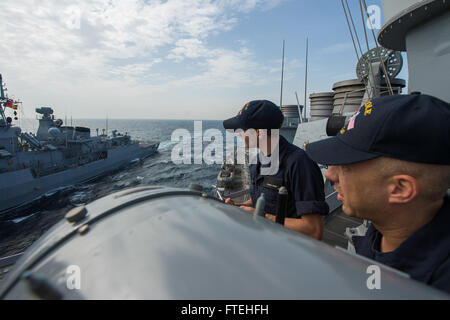 BLACK SEA (Oct. 16, 2014) – Ensign Michael Tomsic and Quartermaster 1st Class Christopher Allison aboard the Arleigh Burke-class guided-missile destroyer USS Cole (DDG 67) conduct communications exercises with the Turkish navy Barbaros-class frigate TCG Salihreis (F 246) during a passing exercise. Cole, homeported in Norfolk, Va., is conducting naval operations in the U.S. 6th Fleet area of operations in support of U.S. national security interests in Europe. Stock Photo